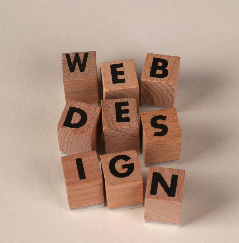 Wooden blocks arranged to spell 'Web Design'. Perfect for creative, digital content themes.